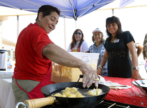 Leah Hogsten  |  The Salt Lake Tribune
A line of people wait for "Rositas Picarones", a traditional Peruvian fried pastry made of sweet potatoes and squash, cooked by Rosa Calderon (left) who learned the art of making them from her grandmother as a young girl in Lima Peru at he 3rd annual Peru Fest, July 25, 2014 at the Utah Multicultural Center.