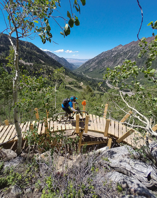 Francisco Kjolseth  |  The Salt Lake Tribune
A wood bridge spans a rock outcropping with the view of Little Cottonwood Canyon as Snowbird Ski and Summer Resort opens their new Big Mountain biking trail this July. Riders can take the tram up and bike down 7.9 miles, dropping more than 2,900 vertical feet.