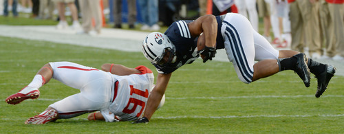 Steve Griffin  |  The Salt Lake Tribune


BYU Cougars running back Paul Lasike (33) gets knocked into the air by Houston Cougars defensive back Adrian McDonald (16) during game between BYU and Houston and LaVell Edwards Stadium in Provo, Thursday, September 11, 2014.