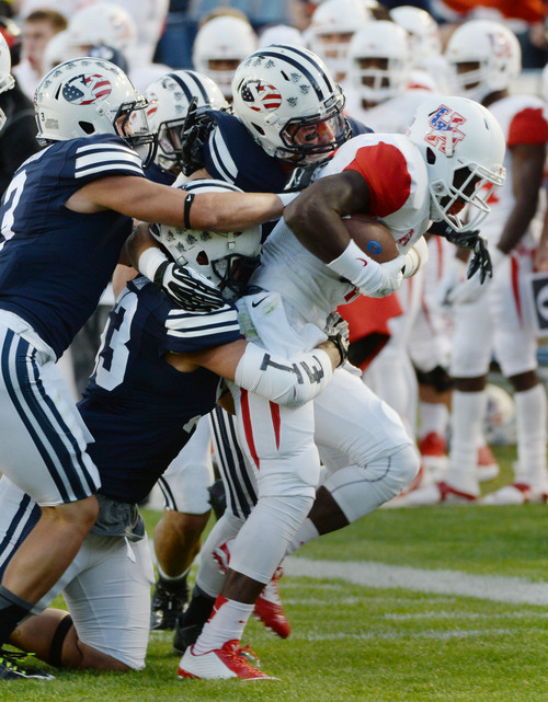 Steve Griffin  |  The Salt Lake Tribune


The BYU defense gang tackle Houston Cougars wide receiver Demarcus Ayers (10) during game between BYU and Houston and LaVell Edwards Stadium in Provo, Thursday, September 11, 2014.