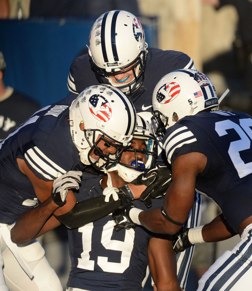 Steve Griffin  |  The Salt Lake Tribune


BYU Cougars wide receiver Devon Blackmon (19) is mobbed by his teammates after getting into the end zone during game between BYU and Houston and LaVell Edwards Stadium in Provo, Thursday, September 11, 2014. The play was called back because of a penalty.