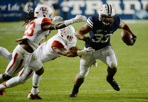 Steve Griffin  |  The Salt Lake Tribune


BYU Cougars running back Paul Lasike (33) runs past the Houston defense in the second half of the  game between BYU and Houston and LaVell Edwards Stadium in Provo, Thursday, September 11, 2014.