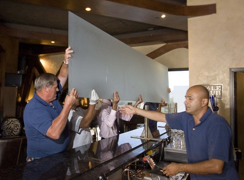 Paul Fraughton  |  Tribune file photo

Moshen Asgari, right, supervises the removal of the "Zion curtain" from the bar at his Vuda Bar and Winery in Draper.