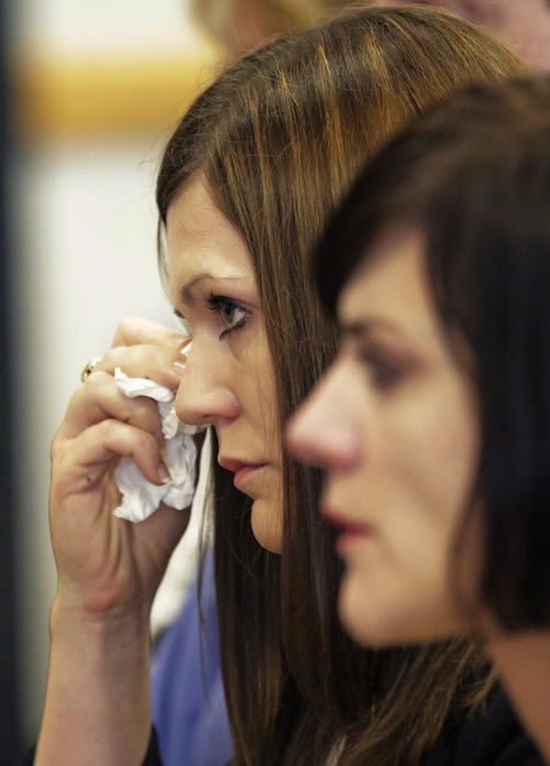 Martin MacNeill daughter Alexis Somers wipes a tear from her face after speaking to the court during her fathers sentencing Friday, Sept. 19, 2014, in Provo, Utah. MacNeill, a Utah doctor convicted of killing his wife in a trial that became a national true-crime cable TV obsession has been sentenced to 17 years to life in prison. MacNeill was found guilty of giving his wife drugs prescribed after cosmetic surgery and leaving her to drown in the bathtub of their home in 2007 so he could begin a new life with his mistress. (AP Photo/Rick Bowmer)