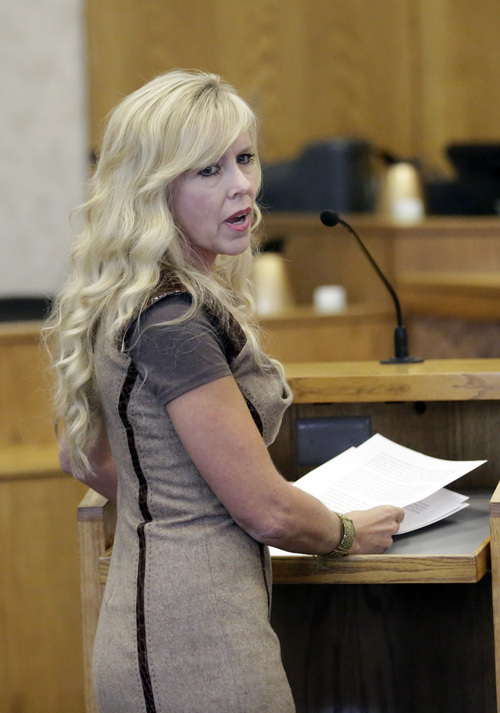 Linda Cluff, sister of Michelle MacNeill, speaks to Martin MacNeill during his sentencing Friday, Sept. 19, 2014, in Provo, Utah. MacNeill, a Utah doctor convicted of killing his wife in a trial that became a national true-crime cable TV obsession has been sentenced to 17 years to life in prison. MacNeill was found guilty of giving his wife drugs prescribed after cosmetic surgery and leaving her to drown in the bathtub of their home in 2007 so he could begin a new life with his mistress. (AP Photo/Rick Bowmer)