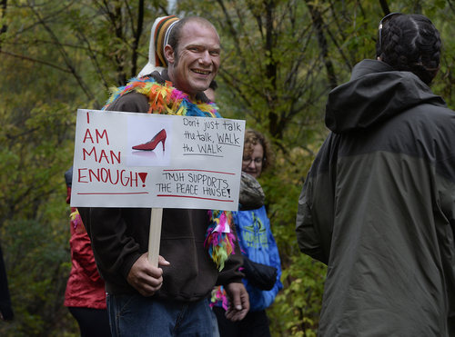 Scott Sommerdorf   |  The Salt Lake Tribune
Aaron Mitchell held a sign proclaiming his manliness as he began the walk to Main Street in Park City during the second annual "Walk a Mile in Her Shoes® Park City" in Park City, Sunday, September 21, 2014.