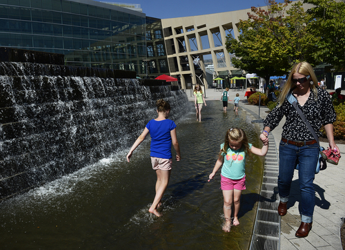 Scott Sommerdorf   |  The Salt Lake Tribune
Visitors to the Clean Air Fair take advantage of the fountain to cool off their feet at Library Square, Saturday, September 20, 2014.