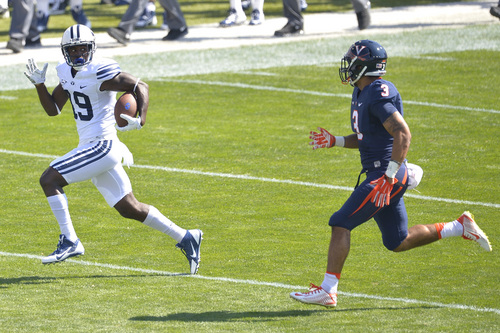 Chris Detrick  |  The Salt Lake Tribune
Brigham Young Cougars wide receiver Devon Blackmon (19) runs past Virginia Cavaliers safety Quin Blanding (3) during the game at LaVell Edwards Stadium Saturday September 20, 2014.  Virginia is winning the game 16-13 at halftime.