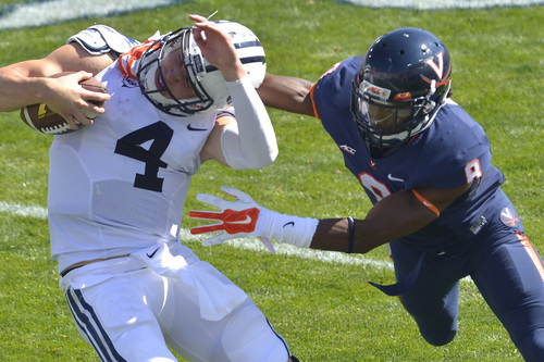 Chris Detrick  |  The Salt Lake Tribune
Brigham Young Cougars quarterback Taysom Hill (4) is tackled by Virginia Cavaliers safety Anthony Harris (8) during the game at LaVell Edwards Stadium Saturday September 20, 2014. No flag was thrown on the play. Virginia is winning the game 16-13 at halftime.