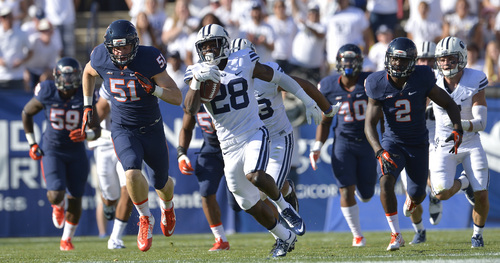 Chris Detrick  |  The Salt Lake Tribune
Brigham Young Cougars running back Adam Hine (28) runs for a 100-yard touchdown during the second half of the game at LaVell Edwards Stadium Saturday September 20, 2014.  BYU won the game 41-33.