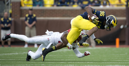 Jeremy Harmon  |  The Salt Lake Tribune

Michigan's Jehu Chesson (86) is tackled by Utah's Justin Thomas (12) as the Utes face the Wolverines in Ann Arbor, Saturday, Sept. 20, 2014.