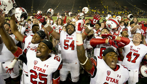 Jeremy Harmon  |  The Salt Lake Tribune

Utah's Isaac Asiata (54) and the rest of the team celebrate after Utah beat Michigan in Ann Arbor, Saturday, Sept. 20, 2014.