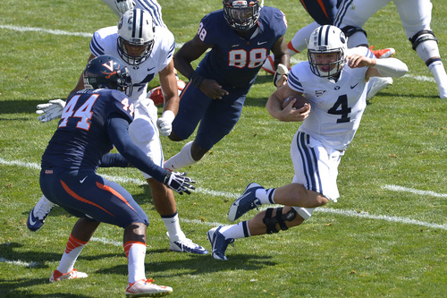 Chris Detrick  |  The Salt Lake Tribune
Brigham Young Cougars quarterback Taysom Hill (4) runs past Virginia Cavaliers linebacker Henry Coley (44) and Virginia Cavaliers linebacker Max Valles (88) during the game at LaVell Edwards Stadium Saturday September 20, 2014.  Virginia is winning the game 16-13 at halftime.