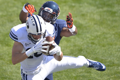 Chris Detrick  |  The Salt Lake Tribune
Virginia Cavaliers safety Brandon Phelps (21) defends Brigham Young Cougars wide receiver Mitch Mathews (10) as Mathews can't make a potential touchdown catch during the game at LaVell Edwards Stadium Saturday September 20, 2014.  Virginia is winning the game 16-13 at halftime.