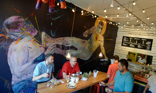 Francisco Kjolseth  |  The Salt Lake Tribune
Local artist Ben Wiemeyer graces the wall of Taco Taco, a new place by the same owners of Cannella's next door just South of Library Square in downtown Salt Lake. Long-time Cannella's chef, Alberto Higuera, a native of Baja Mexico, is making authentic street tacos, quesadillas and burritos in the tiny spot that only seats about 15 people.