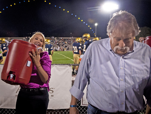 Michael Mangum  |  Special to The Salt Lake Tribune

KUTV 2News reporter Shauna Lake prepares to dump a bucket of ice water on Tribune columnist Robert Kirby during halftime of the Skyline Homecoming football game at Skyline High School on Friday, September 19, 2014.