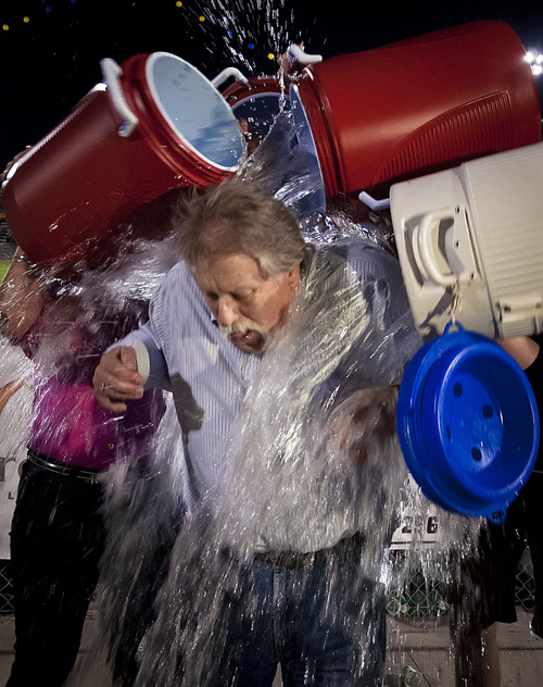 Michael Mangum  |  Special to The Salt Lake Tribune

Tribune columnist Robert Kirby participates in the ALS Ice Bucket Challenge, getting drenched by KUTV 2News reporter Shauna Lake and Skyline High student body officers during halftime of the Skyline Homecoming football game at Skyline High School on Friday, September 19, 2014.