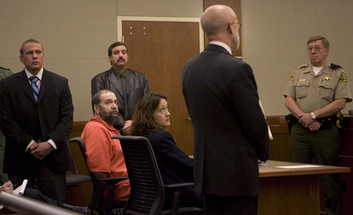 Prison Corrections guards and Sheriff Bailiff in back row watch over death row inmate Ralph Menizies with his advisor Elizabeth Hunt in Third District Court on Friday.  They are listening to Michael Zimmerman, right, speaking on behalf of the Utah Association of Criminal Defense Lawyers encouraging  Judge Stephen Roth to increase the pay for court appointed defense lawyers for Menzies.   Third District Judge Stephen Roth ruled that an unwilling lawyer can be forced to represent Menzies but only if the pay is adequate.   Menzies' appeal has been stalled for 11 months as lawyer after lawyer refuses to take the case.    Al Hartmann/Salt Lake Tribune    11/16/07