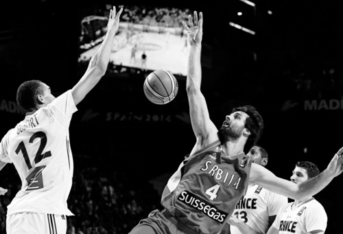 Serbia's Milos Teodosic, right, vies for the ball with France's Rudy Gobert during a basketball World Cup semifinal match between France and Serbia at the Palacio de los Deportes stadium in Madrid, Spain, Friday, Sept. 12, 2014. (AP Photo/Daniel Ochoa de Olza)