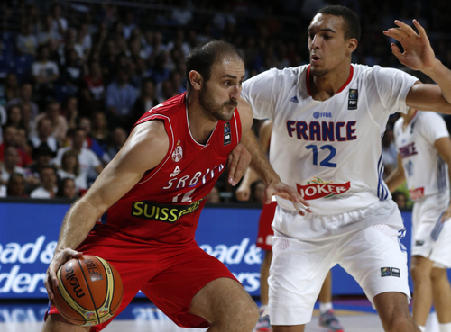 Serbia's Nenad Krstic drives the ball against France's Rudy Gobert during a basketball World Cup semifinal match between France and Serbia at the Palacio de los Deportes stadium in Madrid, Spain, Friday, Sept. 12, 2014. (AP Photo/Daniel Ochoa de Olza)