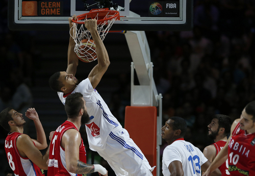 France's Rudy Gobert pushes the ball inside the basket during a basketball World Cup semifinal match between France and Serbia at the Palacio de los Deportes stadium in Madrid, Spain, Friday, Sept. 12, 2014. (AP Photo/Daniel Ochoa de Olza)