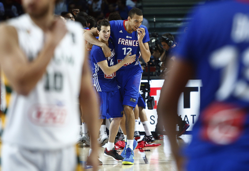 France's Rudy Gobert and Thomas Heurtel celebrate their bronze medal at the end of the match during the 3rd place final of the World Basketball between France and Lithuania at the Palacio de los Deportes stadium in Madrid, Spain, Saturday, Sept. 13, 2014. (AP Photo/Andres Kudacki)