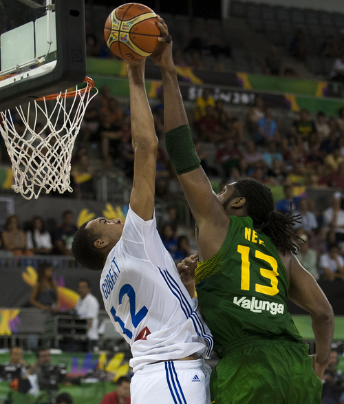 Brazil's Maybyner Rodney Hilario Nene, right, shoots over France's Guilherme Giovannoni, left, during the Group A Basketball World Cup match between Brazil and France in Granada, Spain, Saturday, Aug. 30, 2014. The 2014 Basketball World Cup competition will take place in various cities in Spain from Aug. 30 through to Sept. 14. (AP Photo/Daniel Tejedor)