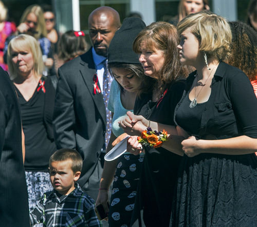 Steve Griffin  |  The Salt Lake Tribune

Susan Hunt is consoled as she follows pallbearers carrying the casket of her son, Darrien Hunt, after funeral services at the Saratoga Springs North Stake Center in Saratoga Springs, Utah Thursday, Sept. 18, 2014. Police officers in Saratoga Springs shot and killed Hunt on Sept. 10, 2014.