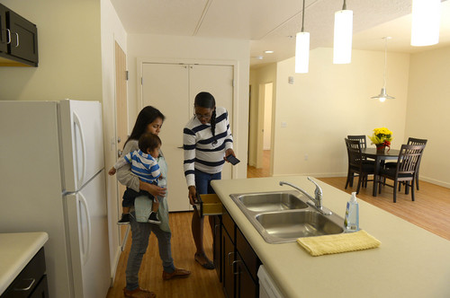 Leah Hogsten  |  The Salt Lake Tribune
Bud Bailey Apartment Complex residents l-r Catalina Barrios, holding son Tyson Jr., and Jasmine Louis compare the appliances and fixtures in the model apartment to their own. Salt Lake County and County Housing Authority officials dedicated 72 new housing units located at the Bud Bailey Apartment Complex, 3970 S. Main St., which are designed in part to provide housing for low-income and end chronic homelessness, Wednesday, Sept. 24, 2014.