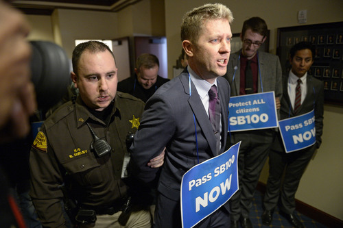 Francisco Kjolseth  |  The Salt Lake Tribune
LGBT activist Troy Williams is arrested along with other supporters after blocking the doors to Senate committee room 210 at the Utah State Capitol on Monday, Feb. 9, 2014, in an effort to bring attention to anti-discrimination bill SB 100 with hopes of a hearing.
 Williams will be the new leader of Equality Utah, a gay rights group.