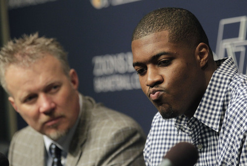Al Hartmann  |  The Salt Lake Tribune
Utah Jazz power forward Derrick Favors ponders a question during a press conference Monday October 28, 2013 in Salt Lake City. He was offered a multi-year contract extension. Jazz owner, Greg Miller, is at left.