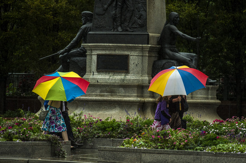 Chris Detrick  |  The Salt Lake Tribune
Pedestrians attempt to stay dry under umbrellas while walking down South Temple Street in Salt Lake City Saturday September 27, 2014.