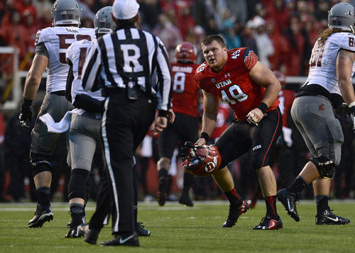 Scott Sommerdorf   |  The Salt Lake Tribune
Utah DE Hunter Dimick reacts after his helmet was pulled off by a Washington State lineman. The Cougars were called for an illegal hands to the face penalty on the play. Utah took a quick 21-0 lead over Washington State in t he first quarter, Saturday, September 27, 2014.