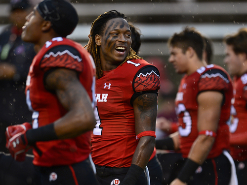 Scott Sommerdorf   |  The Salt Lake Tribune
Utah DB Boobie Hobbs laughs with team mates as he and other players stretch in a steady rain prior to facing off against Washington State, Saturday, September 27, 2014.
