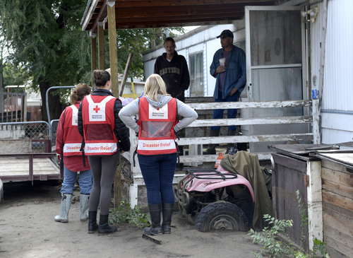 Al Hartmann  |  The Salt Lake Tribune
Red Cross members check in with homeowners Monday Sept. 29, 2014, at the Pilling Trailer Park in Carbonville near Price. Many trailers are unlivable from the flooding caused by the Price River overflowing its banks Saturday night. On Sunday most people at the park dug out what they could and removed belongings.