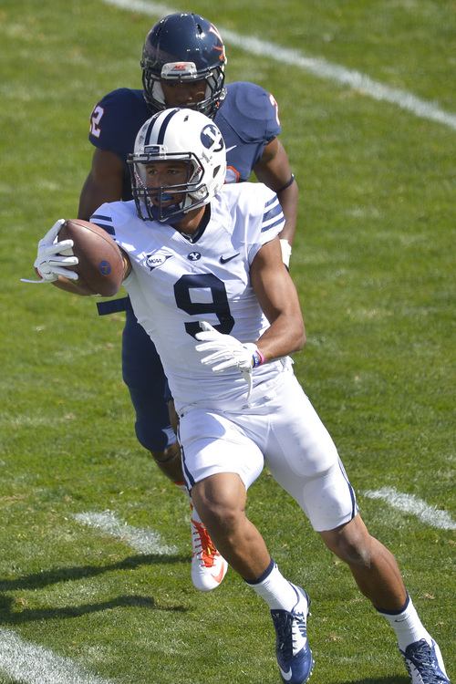 Chris Detrick  |  The Salt Lake Tribune
Brigham Young Cougars wide receiver Jordan Leslie (9) scores a touchdown past Virginia Cavaliers cornerback DreQuan Hoskey (22) during the game at LaVell Edwards Stadium Saturday September 20, 2014.  Virginia is winning the game 16-13 at halftime.