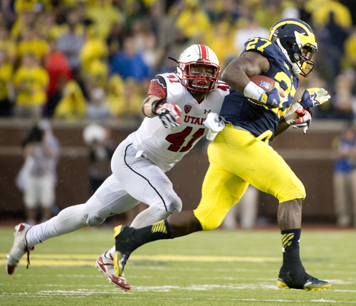 Jeremy Harmon  |  The Salt Lake Tribune

Utah's Jared Norris (41) just misses a tackle on Michigan's Derrick Green (27) as the Utes face the Wolverines in Ann Arbor, Saturday, Sept. 20, 2014.