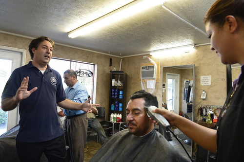 Scott Sommerdorf  |  The Salt Lake Tribune
Salt Lake City Councilman Kyle LaMalfa speaks with hair stylist Arcelia Hurtado as she cuts Juan Flores' hair at the Cesar Hair Salon on 900 West in the west side of Salt Lake. The new West Side Master Plan will soon be adopted by the Salt Lake City Council. It is a blueprint for future development of the Glendale and Poplar Grove neighborhoods.