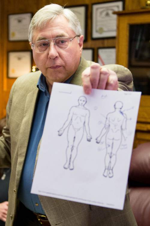Trent Nelson  |  The Salt Lake Tribune
Attorney Robert Sykes holds an autopsy report while speaking at a press conference in Salt Lake City, Friday October 17, 2014. An autopsy report released Friday says Darrien Hunt was shot several times in the back by Saratoga Springs police officers chasing him.