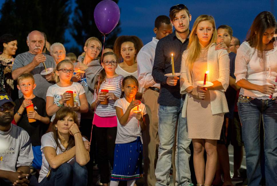 Trent Nelson  |  The Salt Lake Tribune
Susan Hunt, lower left, listens to stories about her son, Darrien Hunt, at a candlelight vigil Sunday September 14, 2014 for Darrien, who was shot and killed by Saratoga Springs police.