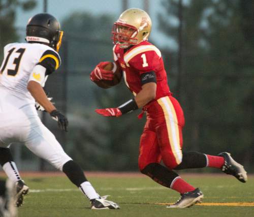 Rick Egan  |  The Salt Lake Tribune

Sport Falemaka (1) runs the ball for the Bulldogs, as Union (13) defends, in prep football action, Judge Memorial vs. Union High School, at Judge Memorial, Friday, September 19, 2014