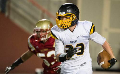 Rick Egan  |  The Salt Lake Tribune

Sean Thompson (33) runs the ball for Union, in prep football action, Judge Memorial vs. Union High School, at Judge Memorial, Friday, September 19, 2014