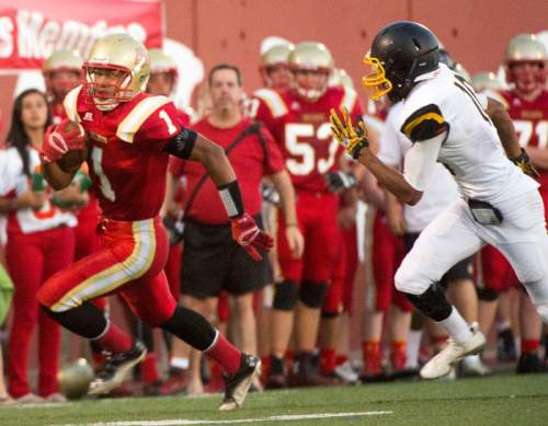 Rick Egan  |  The Salt Lake Tribune

Sport Falemaka (1) runs the ball for the Bulldogs, as Union's Everet Miller (10) chases him down, in prep football action, Judge Memorial vs. Union High School, at Judge Memorial, Friday, September 19, 2014