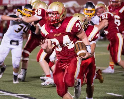 Rick Egan  |  The Salt Lake Tribune

Max Barnett (34) runs for this third touchdown of the night for the Bulldogs, in prep football action Judge Memorial vs. Union High School, at Judge Memorial, Friday, September 19, 2014