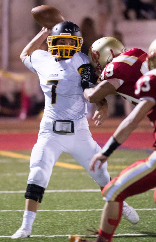 Rick Egan  |  The Salt Lake Tribune

Zach Roll is hit by Tofa Fangaa (89) Judge,  as he throws the ball for the Cougars, in prep football action Judge Memorial vs. Union High School, at Judge Memorial, Friday, September 19, 2014