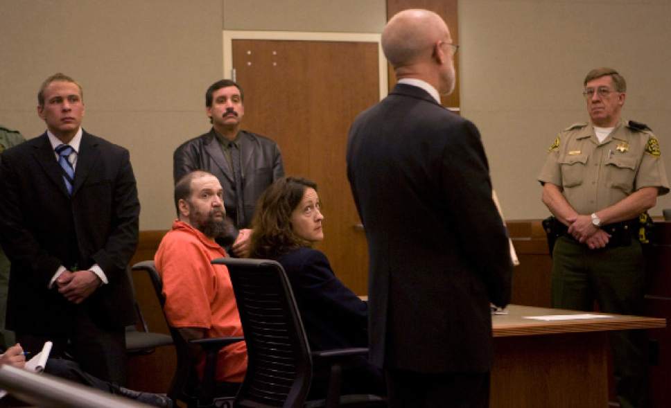 Prison Corrections guards and Sheriff Bailiff in back row watch over death row inmate Ralph Menizies with his advisor Elizabeth Hunt in Third District Court on Friday.  They are listening to Michael Zimmerman, right, speaking on behalf of the Utah Association of Criminal Defense Lawyers encouraging  Judge Stephen Roth to increase the pay for court appointed defense lawyers for Menzies.   Third District Judge Stephen Roth ruled that an unwilling lawyer can be forced to represent Menzies but only if the pay is adequate.   Menzies' appeal has been stalled for 11 months as lawyer after lawyer refuses to take the case.    Al Hartmann/Salt Lake Tribune    11/16/07