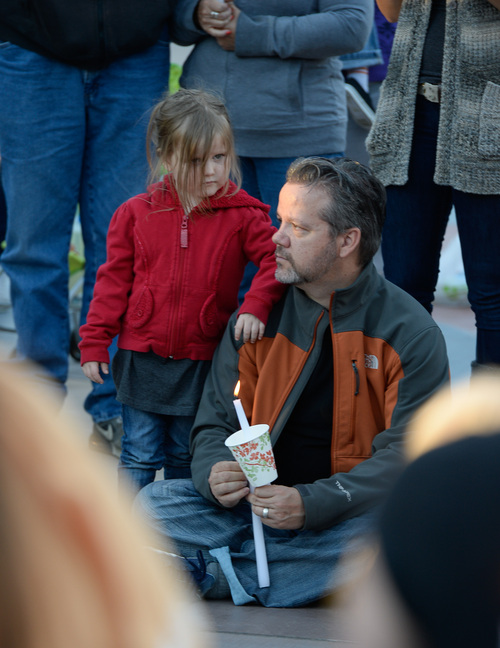 Francisco Kjolseth  |  The Salt Lake Tribune
Issac Strack, brother of Benjamin Strack, who was found found dead alongside his wife and three children last Saturday at their home in Springville, attends a vigil at Pioneer Park in Provo, alongside his daughter Remi, 3.