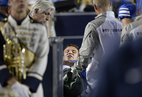 Scott Sommerdorf  |  The Salt Lake Tribune
BYU QB Taysom Hill looks down at his injured leg as he lays on a table on the BYU sidelines after he was injured late in the second half. He left the game on a cart. Utah State led BYU 28-14 at the half in Provo, Friday, October 1, 2014.