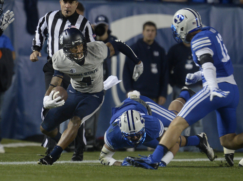 Scott Sommerdorf  |  The Salt Lake Tribune
Utah State Aggies wide receiver Hunter Sharp (4) scrambles for yardage on this first half play. Utah State led BYU 28-14 at the half in Provo, Friday, October 1, 2014.