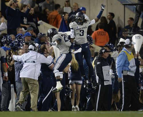 Scott Sommerdorf  |  The Salt Lake Tribune
Utah State Aggies wide receiver Devonte Robinson (3) and USU RB LaJuan Hunt (21) celebrate after a USU TD in the first half. Utah State led BYU 28-14 at the half in Provo, Friday, October 1, 2014.